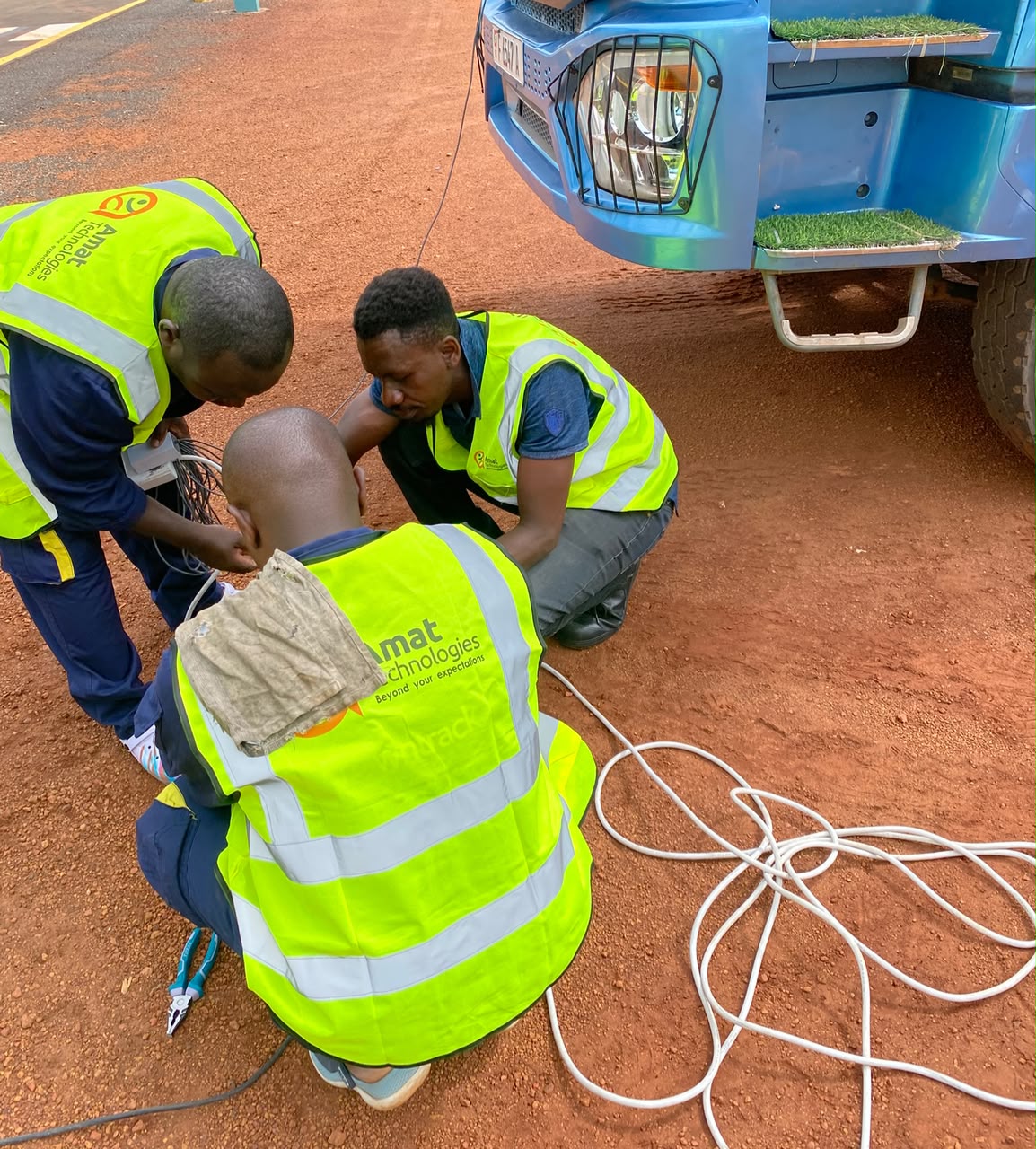 AMAT technicians wiring a fuel probe harness under a tanker truck