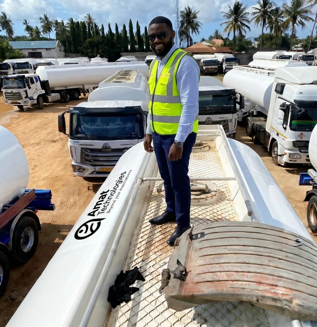 AMAT engineer inspecting a tanker compartment hatch in a heavy fuel truck yard