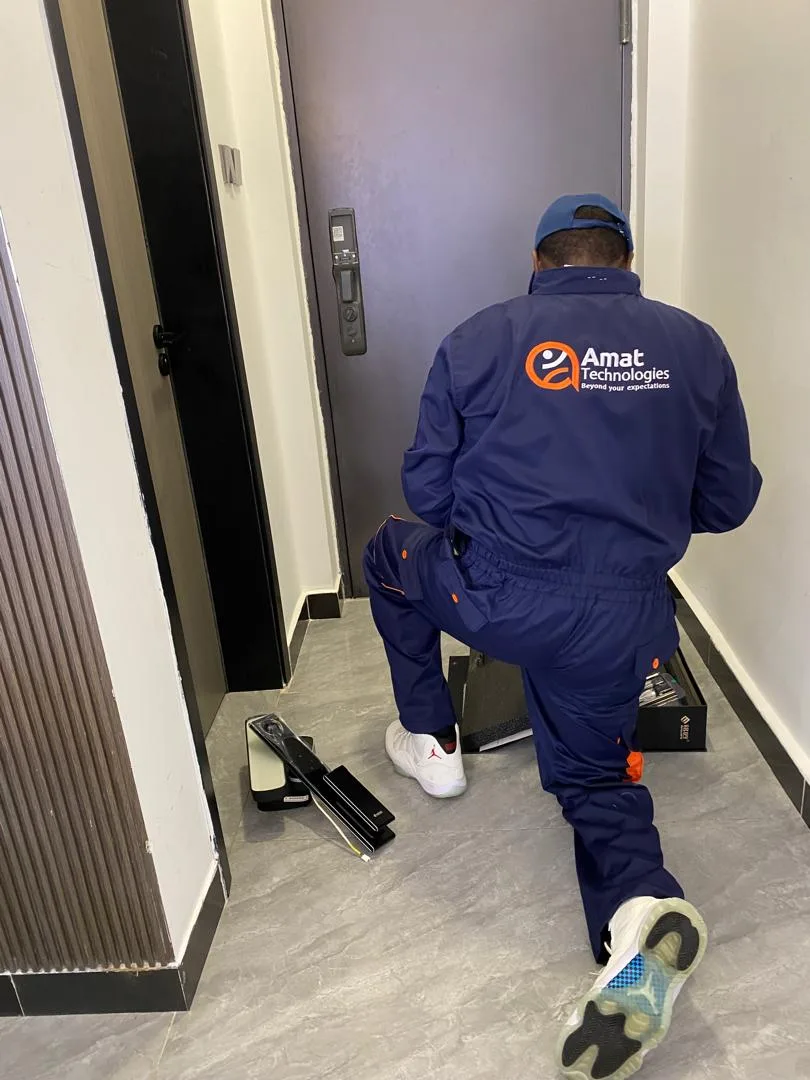 AMAT technician fitting a biometric smart lock on an apartment door