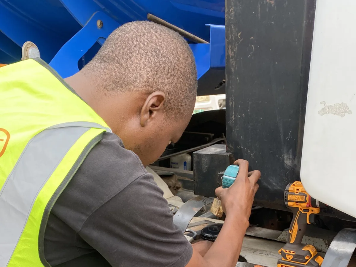 AMAT technician fitting a capacitance fuel probe into a truck diesel tank